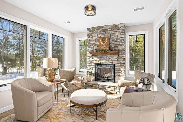 sunroom / solarium featuring a fireplace