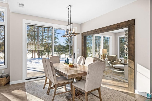 dining room with a notable chandelier and wood-type flooring