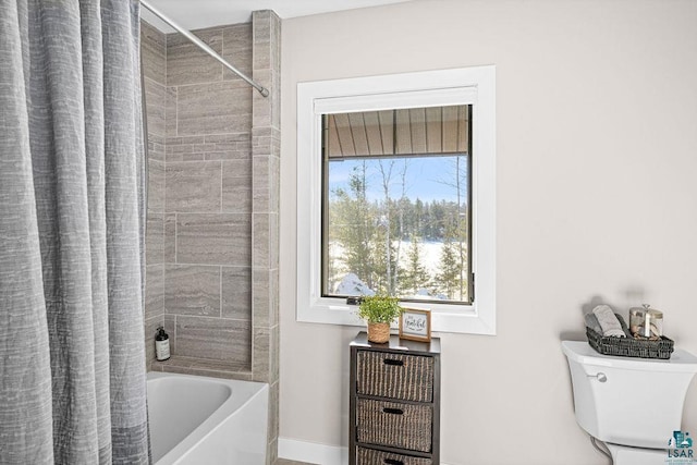 bathroom featuring shower / bath combination with curtain and toilet