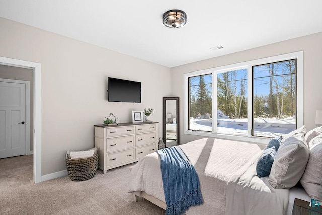 bedroom with access to outside and light colored carpet