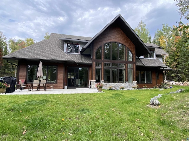 back of house with a lawn and a patio