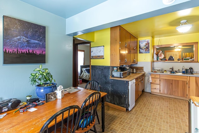 kitchen featuring ceiling fan and sink