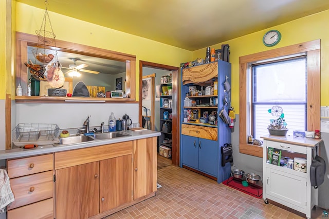 kitchen with ceiling fan, decorative light fixtures, and sink