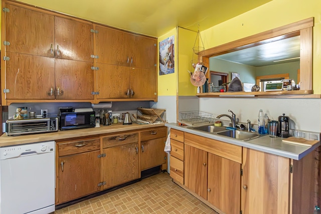 kitchen featuring white dishwasher and sink