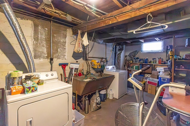 basement featuring washer and dryer and sink