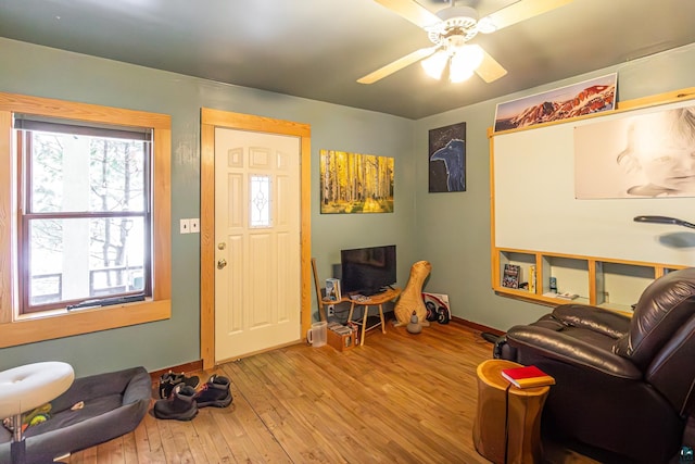 foyer entrance with light hardwood / wood-style flooring and ceiling fan