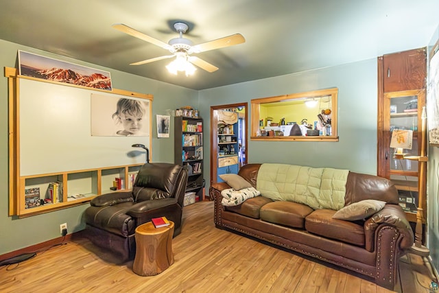 living room with ceiling fan and light wood-type flooring