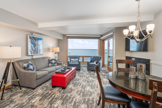 carpeted living room featuring a chandelier