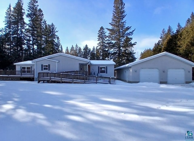 view of front of property featuring an outbuilding, a garage, and a deck