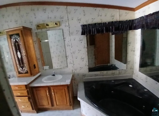 bathroom with a washtub and vanity