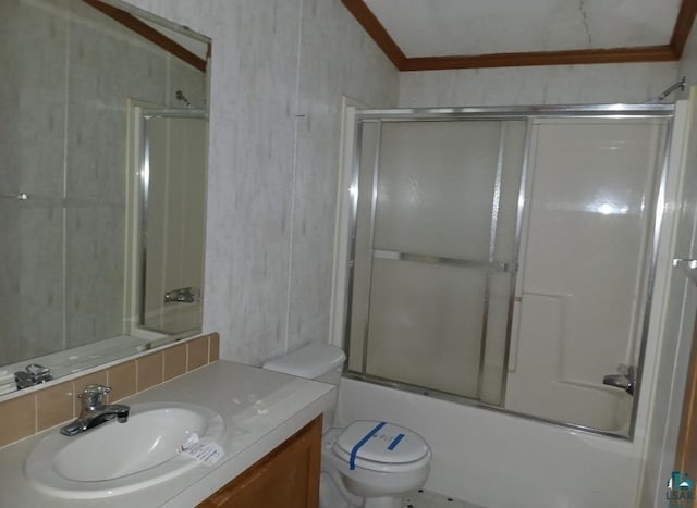 full bathroom with toilet, ornamental molding, vanity, and shower / bath combination with glass door