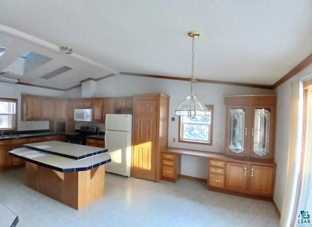 kitchen featuring pendant lighting, white appliances, built in desk, a kitchen bar, and vaulted ceiling