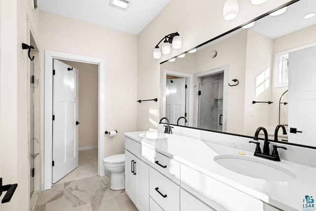 bathroom with a shower with door, vanity, and toilet