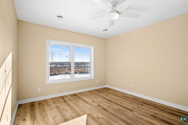 empty room with ceiling fan and light hardwood / wood-style floors