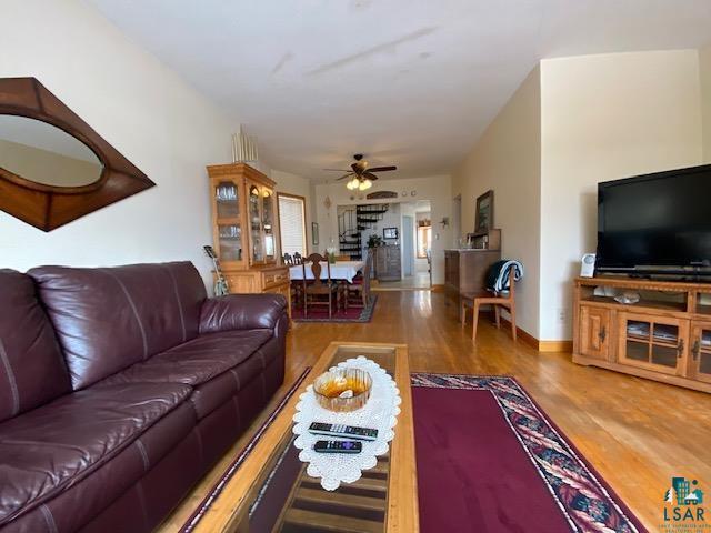 living room with ceiling fan and hardwood / wood-style floors