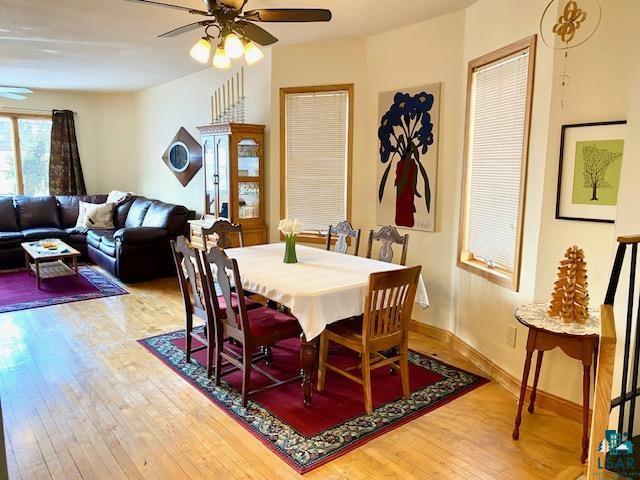 dining space with ceiling fan and hardwood / wood-style floors