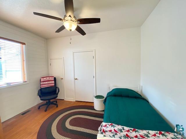 bedroom with hardwood / wood-style flooring and ceiling fan