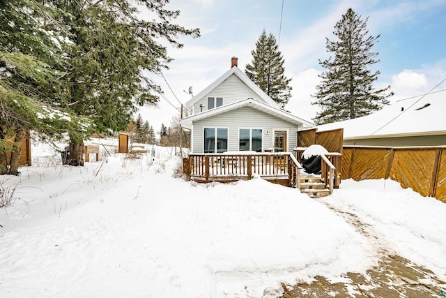 view of snow covered back of property