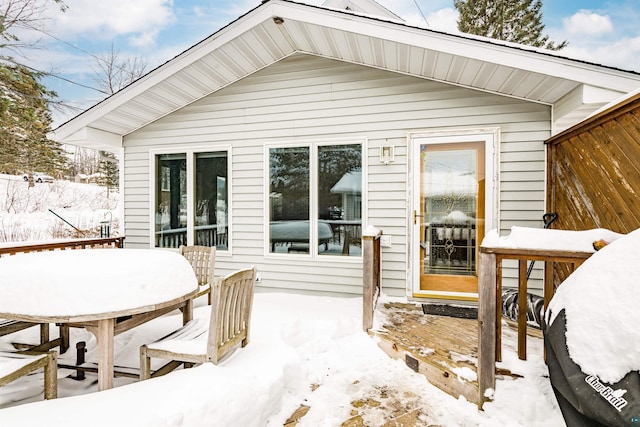 view of snow covered back of property