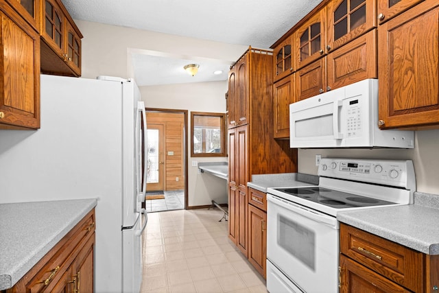 kitchen with a textured ceiling and white appliances