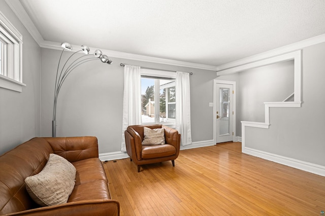 living room featuring ornamental molding and light wood-type flooring