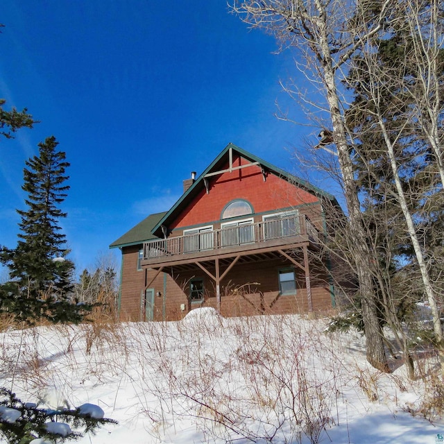 snow covered house with a deck