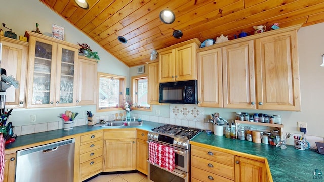 kitchen with lofted ceiling, sink, appliances with stainless steel finishes, light tile patterned flooring, and wooden ceiling