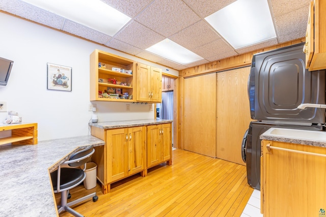 kitchen featuring a drop ceiling and light hardwood / wood-style flooring