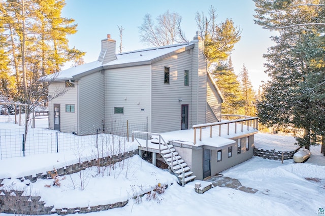 view of snow covered back of property