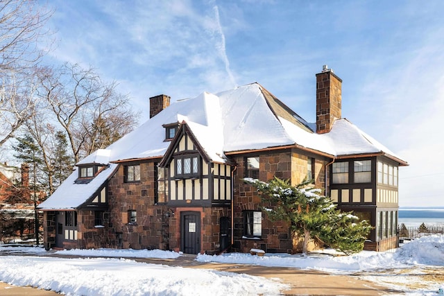 view of snow covered rear of property