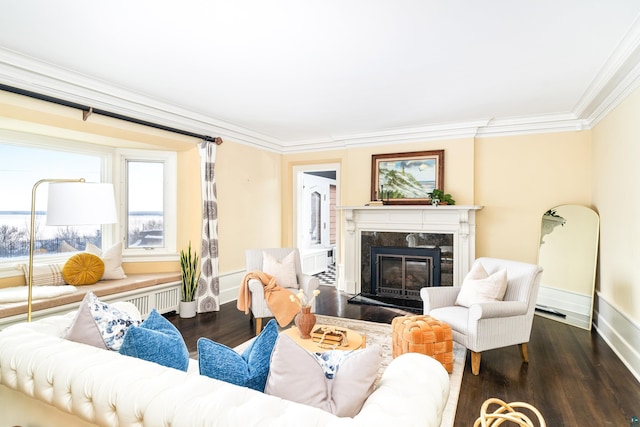 living room with radiator heating unit, crown molding, a high end fireplace, and dark hardwood / wood-style floors