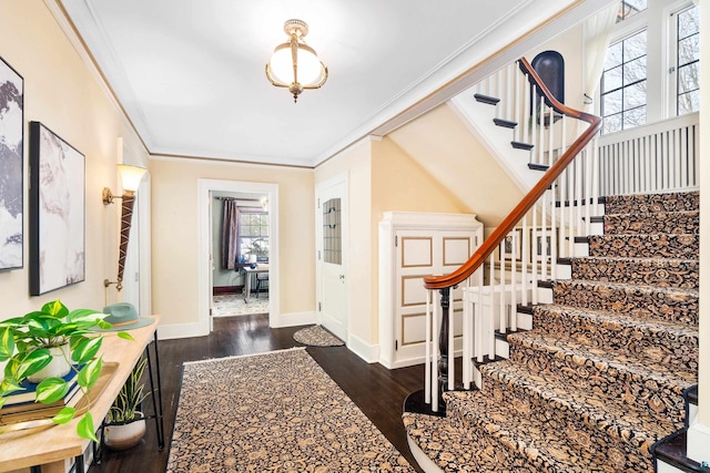 entryway with crown molding and dark wood-type flooring