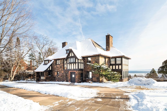 view of snow covered rear of property