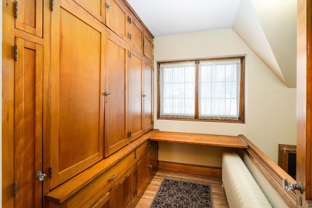 mudroom featuring light hardwood / wood-style flooring and vaulted ceiling