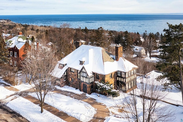 snowy aerial view with a water view