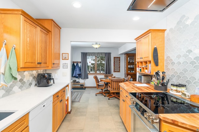 kitchen with stainless steel electric stove, dishwasher, backsplash, and wooden counters