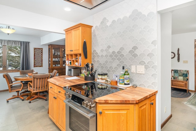 kitchen featuring butcher block countertops and stainless steel range with electric cooktop