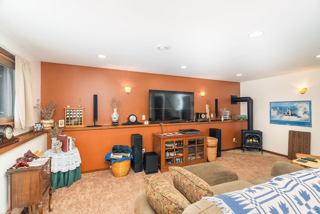 carpeted living room with a wood stove