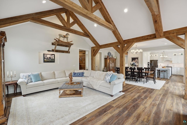 living room featuring an inviting chandelier, beam ceiling, dark wood-type flooring, and high vaulted ceiling