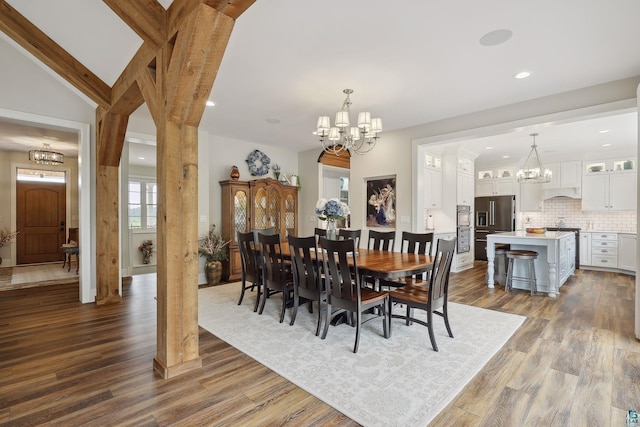 dining area featuring a notable chandelier and dark hardwood / wood-style flooring