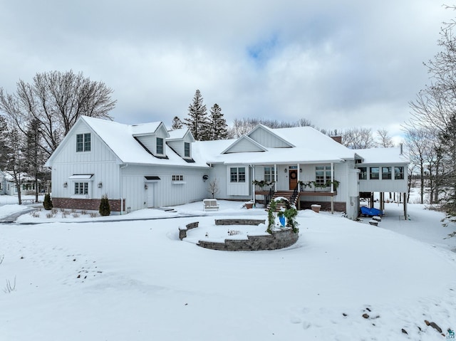 view of snow covered back of property