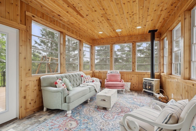 sunroom / solarium featuring wooden ceiling, heating unit, and a wood stove