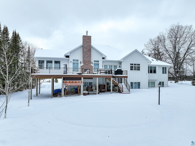 snow covered house featuring a deck