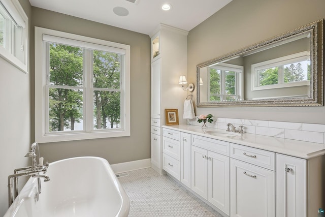 bathroom with vanity, a bathing tub, and tile patterned flooring
