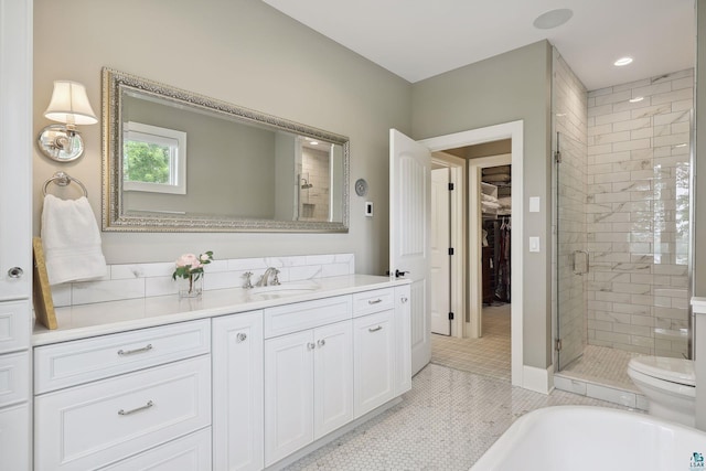 bathroom with vanity, toilet, tile patterned floors, and walk in shower