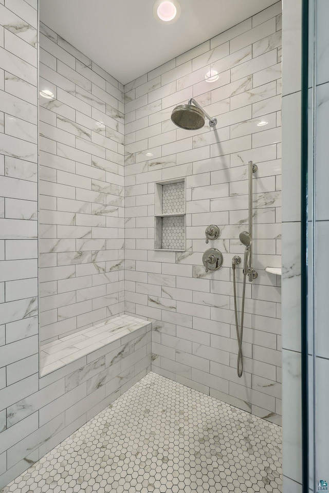 bathroom with a tile shower