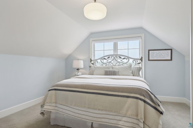 bedroom with lofted ceiling and carpet flooring