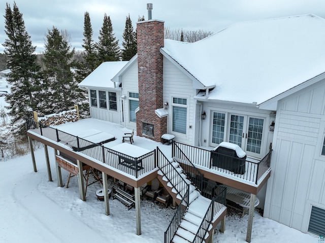 snow covered property featuring a deck