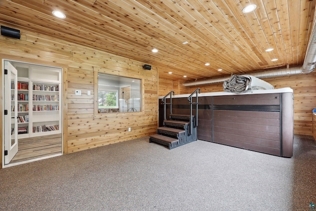 interior space with wooden walls, wood ceiling, and carpet flooring