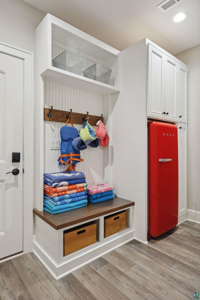 mudroom with light hardwood / wood-style floors